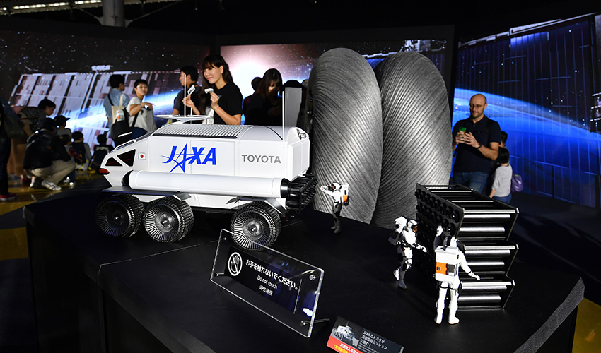 トヨタとJAXAが共同開発中の月面探索車「ローバ」と、ブリヂストンが開発中の月面専用タイヤ